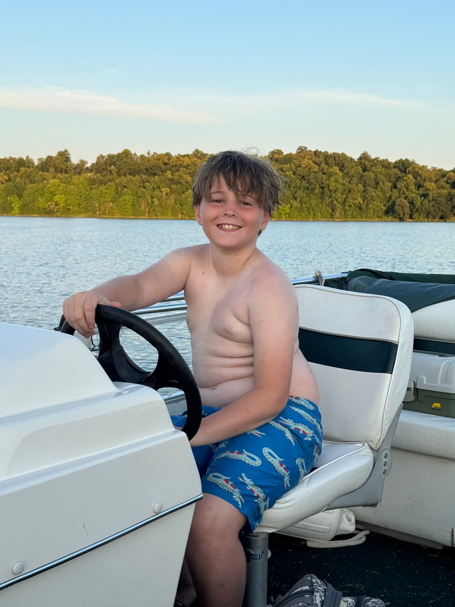 Eli driving the pontoon at Pelican Lake