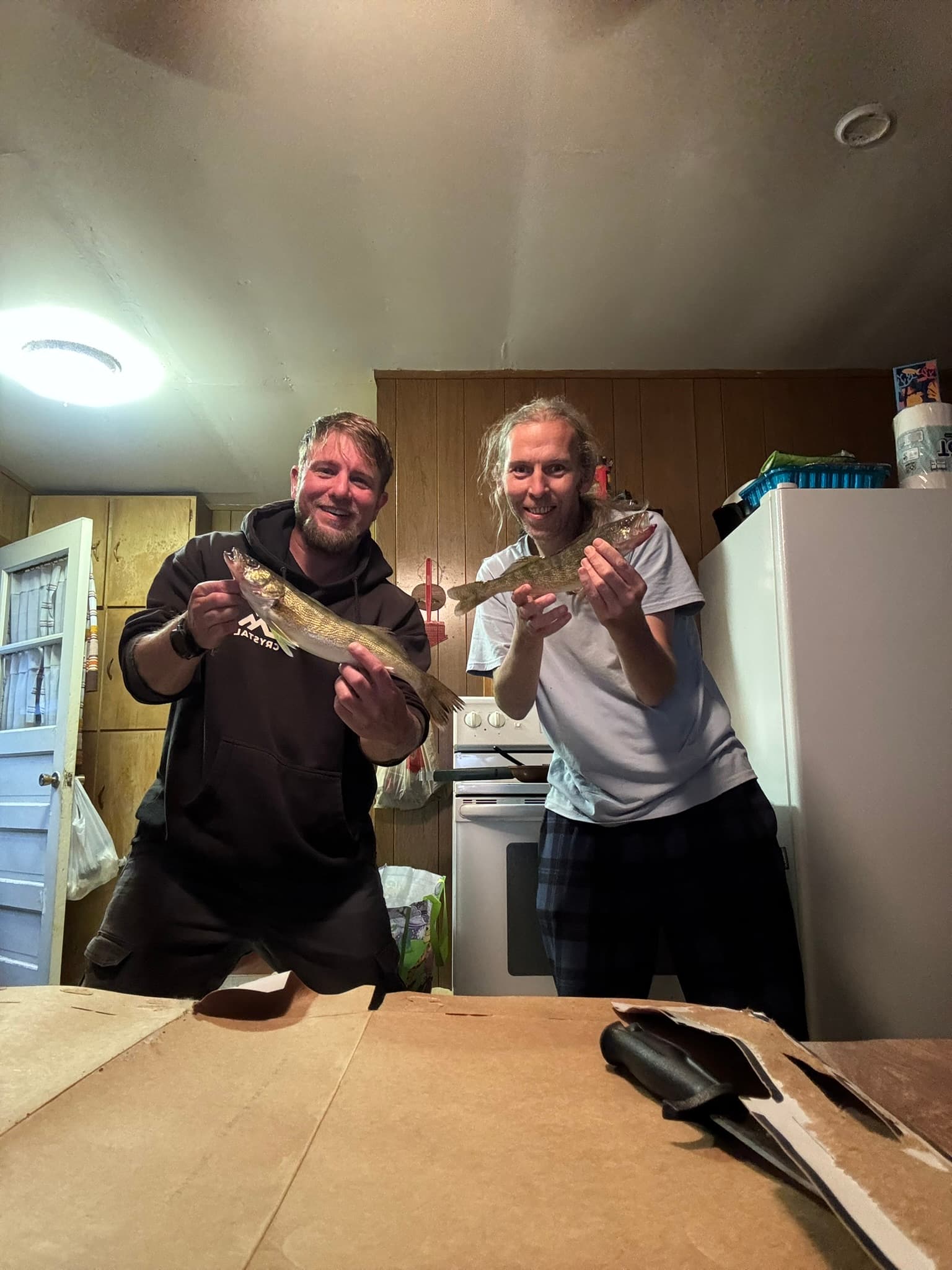 Josh and Jim holding walleye at the cabin